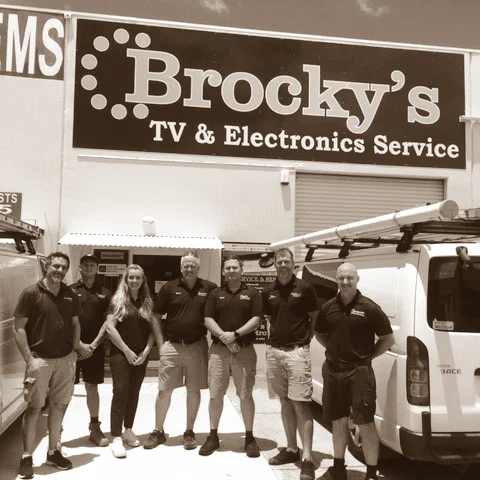 Brocky’s TV team standing outside the TV & Electronics Service shop on the Sunshine Coast
